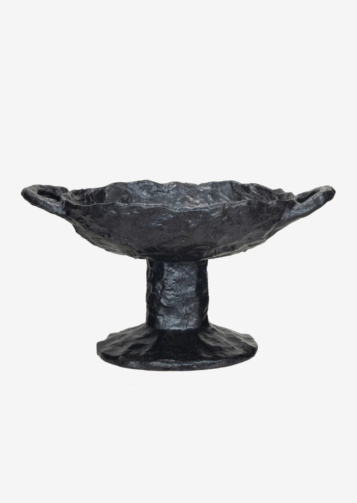 A footed ceramic bowl in black with side handles at top.