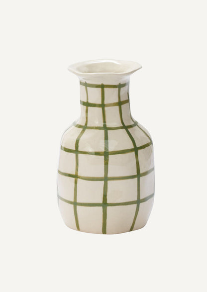 A ceramic vase in white with green grid pattern.