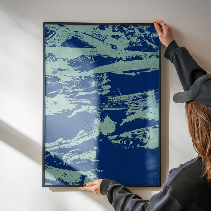 Hands hanging an Inky Blue Graffiti Print, a framed urban style art print on thick paper.