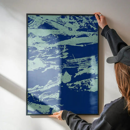 Hands hanging an Inky Blue Graffiti Print, a framed urban style art print on thick paper.