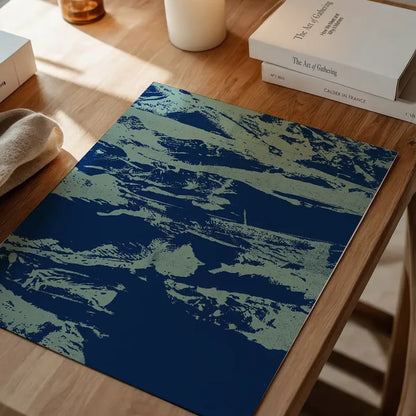 Inky blue graffiti print on thick art paper, featuring urban style art in blue tones on a wooden surface.