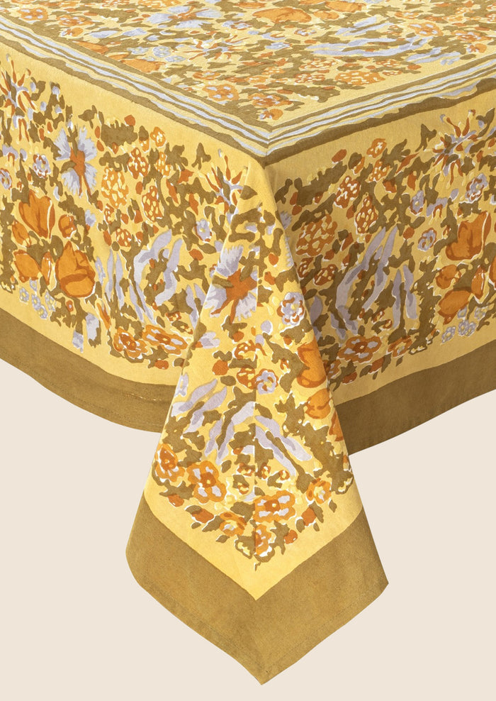 A mustard floral print tablecloth.