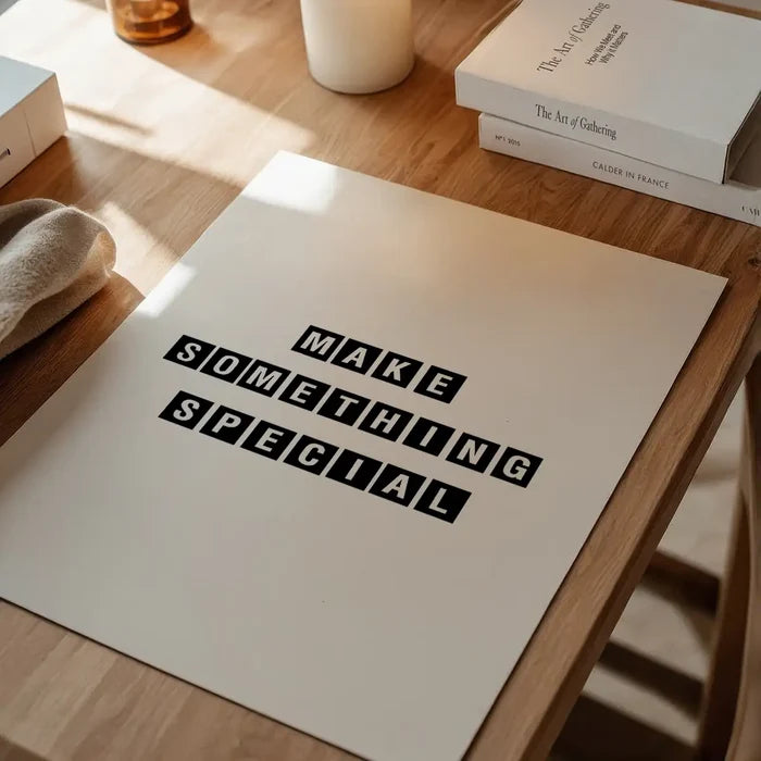 White archival art print with "MAKE SOMETHING SPECIAL" in bold black block letters on a wooden table.