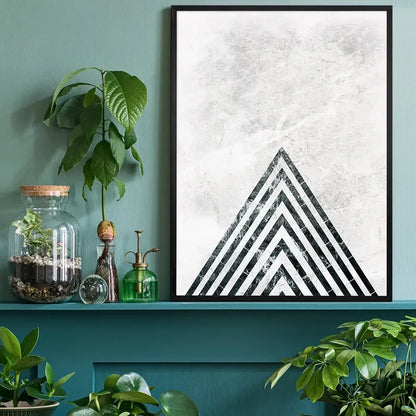 Abstract dark marble point print with black stripes on a textured light background, framed on a teal shelf.