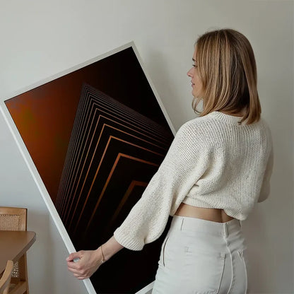 Woman holding a framed orange geometric pyramid print on archival art paper.