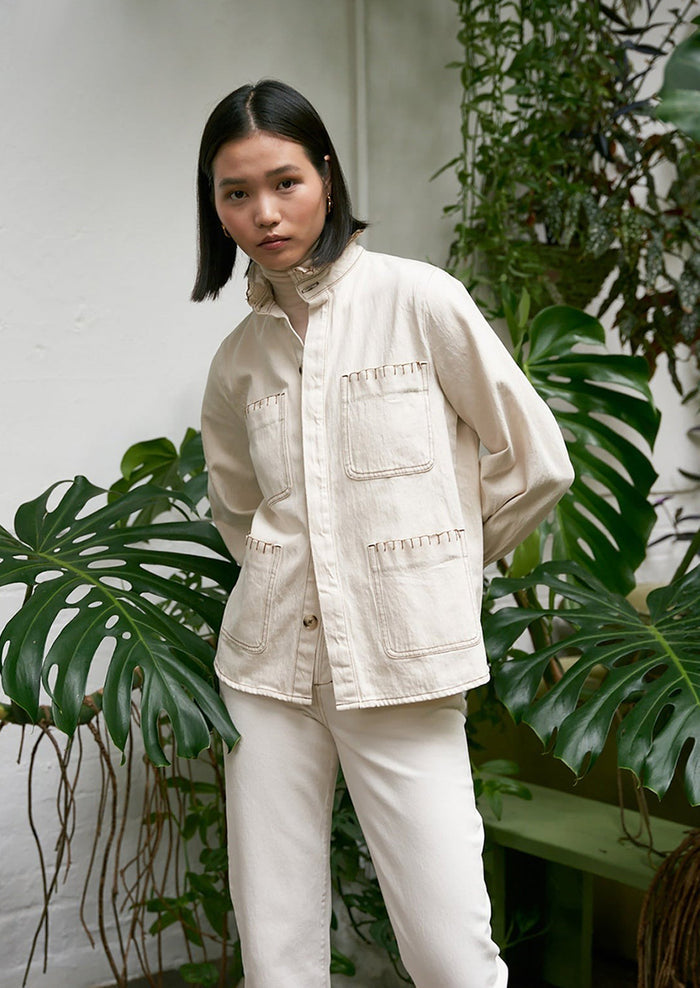 Woman wearing ecru cotton jacket.