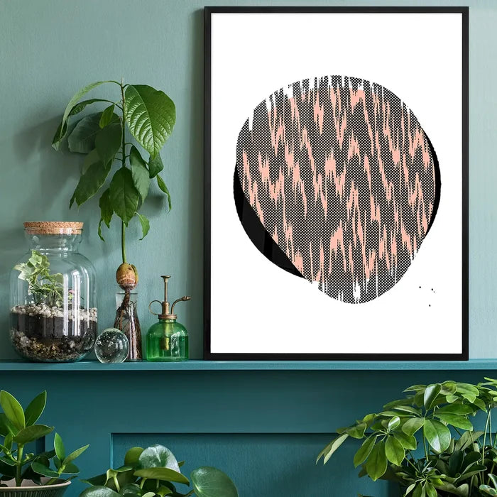 Pebble 1 abstract print with a black circle, pink pattern, and white border in a black frame.