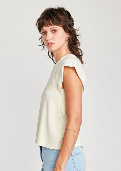 A woman wearing a raglan short sleeve sweatshirt in cream.